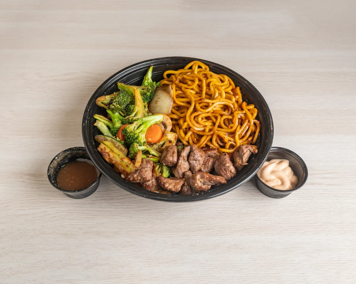 Steak Hibachi — flame-grilled halal steak with lomein, broccoli, carrots, and dipping sauces