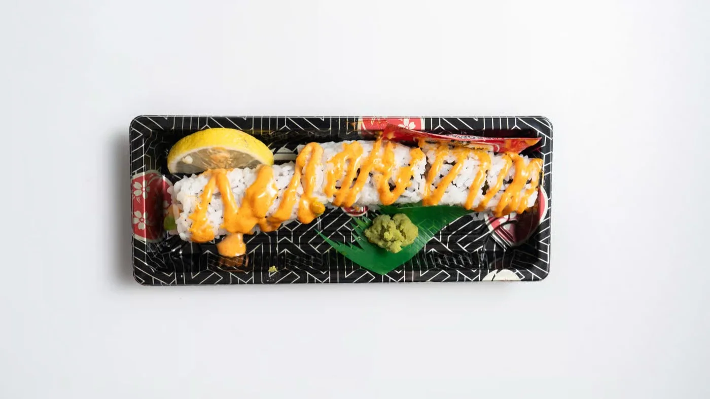 Spicy Tuna Roll topped with spicy mayo drizzle
